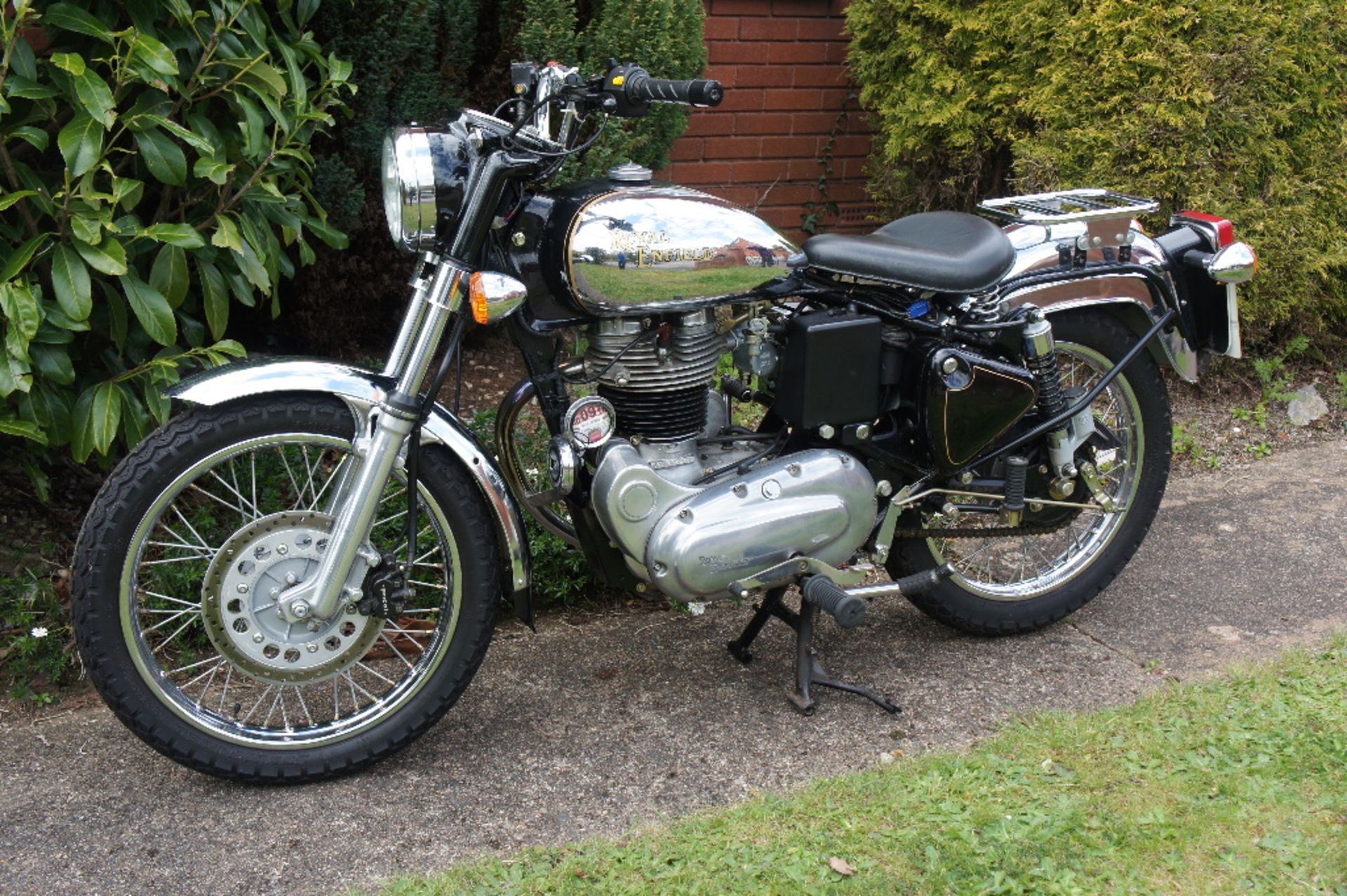 A 2009 Royal Enfield Bullet 350, registration number WA58 NMZ, chrome and black.