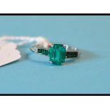 A platinum and emerald ring, with centra