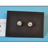 A pair of diamond stud earrings, in a wh