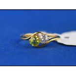 An 18ct gold, peridot and diamond ring