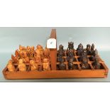 A pottery chess set, in a wooden cradle