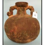 A pre Columbian type twin handled vessel