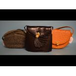 An ostrich handbag, another, and a simil