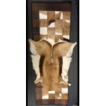 A springbok and leather patchwork throw,