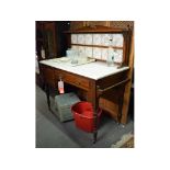 A late Victorian walnut washstand, with a tiled back and a marble top, 107.