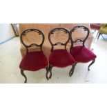 A set of three Victorian style walnut balloon back dining chairs,