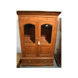 An inlaid cabinet, having a pair of doors with glazed and panelled sections, above two drawers, 97.