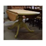 A painted and stripped pine pedestal drop leaf table, 122 cm wide, top loose,