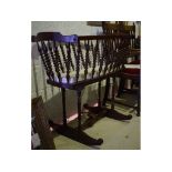 A rocking crib, with turned decoration, 104 cm wide, a pair of oak carver chairs,