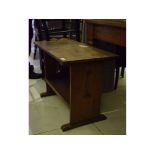 An Arts & Crafts style oak low table, with pierced end supports, 73 cm wide,