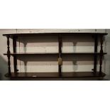 A set of late Victorian three tier hanging wall shelves, with turned supports, 129 cm wide,