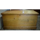 A Victorian stripped pine blanket box, with metal carrying handles to the sides,