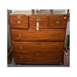 A reproduction teak campaign type chest, bound in brass,