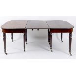 An early 19th century mahogany dining ta