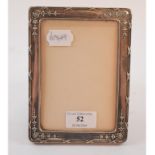 A silver strut photograph frame, with embossed decoration, Birmingham 1919, 16.