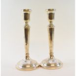 A pair of silver candlesticks, Birmingham 2000, (loaded), 24 cm high, and another pair,