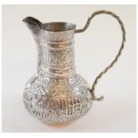 An Islamic silver plated ewer, with embossed decoration, 16 cm high,