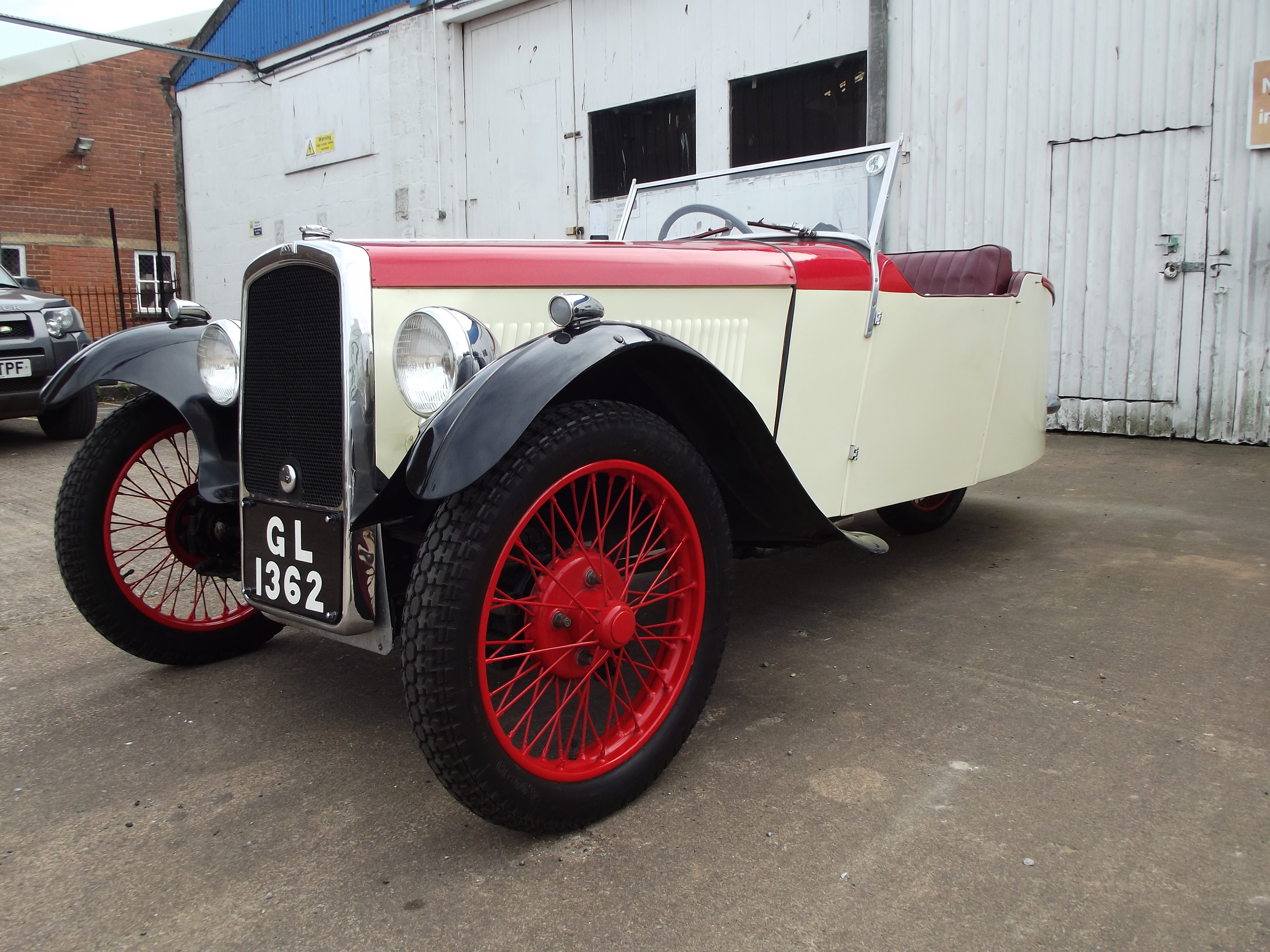 A 1934 BSA TW34-10 Special Sports, registration number GL 1362, red over cream.