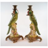 A pair of pottery and gilt metal parrot