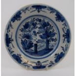 A Delft plate, decorated flowers and fol