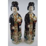A pair of Japanese geisha figures, each