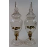 Two glass brandy dispensers, 35 cm high