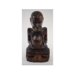 An Eastern carved hardwood figure, 28 cm