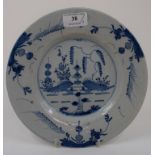 A Delft plate, decorated a garden scene