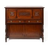 A James Shoolbred desk, having a lift up top above a drop down front revealing a fitted interior,