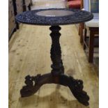 A Burmese carved wood tripod table,