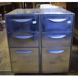 A pair of industrial style stripped and polished steel cabinets, of three graduated drawers,