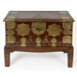 A Zanzibar hardwood chest, with brass strapwork and stud decoration, on a stand,