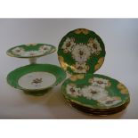 A Mintons part dessert service, with painted and gilt floral decoration, on a green ground, 3529,