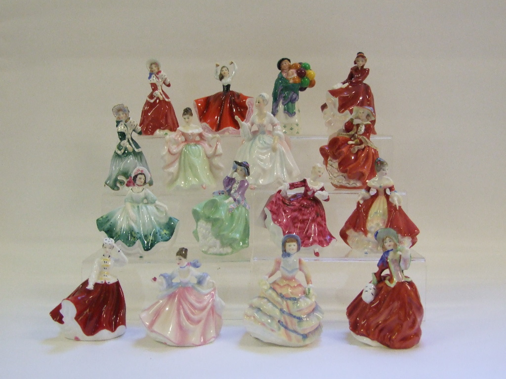 Sixteen Royal Doulton figures, including The Balloon Seller, HN2130, and Christmas Morn,