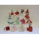 Sixteen Royal Doulton figures, including The Balloon Seller, HN2130, and Christmas Morn,