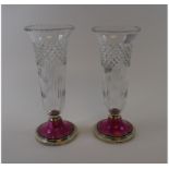 A pair of glass vases, on silver bases with enamel decoration, Birmingham 1926,