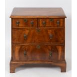 A chest of two short and two graduated long drawers, of small proportions,