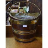 A 19th century mahogany bucket, of navette form, bound in brass,