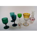 An amber flashed glass wine glass, 15 cm high, a pair of green glass glasses, a liqueur set,