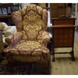 An 18th century style upholstered wing armchair,