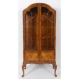 An 18th century style walnut display cabinet, on cabriole legs with pad feet,