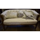 A late Victorian upholstered two seater settee, on fluted front legs,