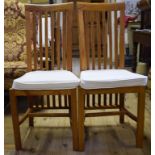 A set of eight teak dining chairs,