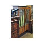 An inlaid mahogany display cabinet, above a pair of cupboard doors, on square legs,