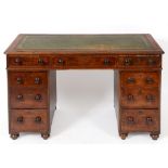 A Victorian mahogany pedestal desk, the leather inset top above an arrangement of nine drawers,