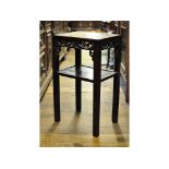 A Chinese hardwood two tier side table, with pierced and carved decoration,