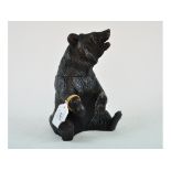 A Black Forest style carved wood bear, the head hinging to reveal a compartment,