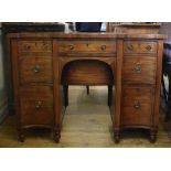 A George III serpentine front mahogany sideboard, with boxwood stringing,