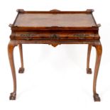 A walnut silver table, having a frieze drawer, on cabriole legs with claw and ball feet,