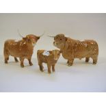 A Beswick Highland Bull, 2008 (hoof chipped), a Highland Cow, 1740, and a Highland calf, 1827D,